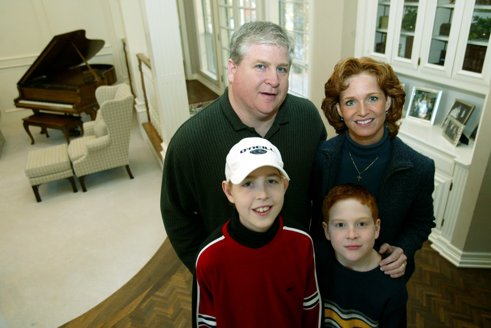 Trey, Kari, TJ, and Patrick Tomeny standing together in their home